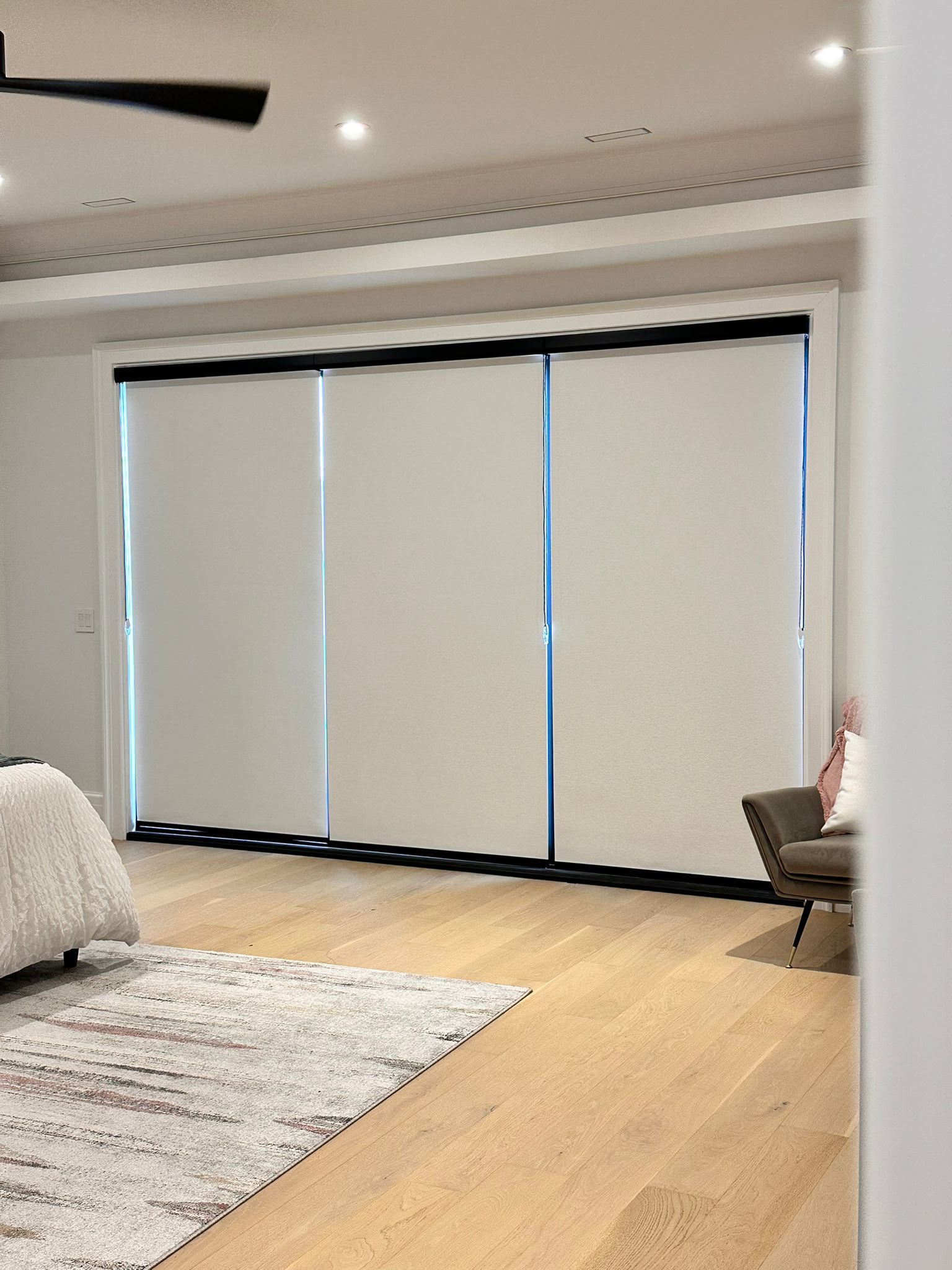 Craftsman measuring roller shade fabric in workshop